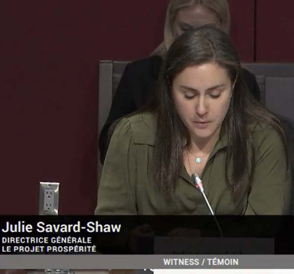Julie Savard-Shaw speaking into microphone in front of the Senate